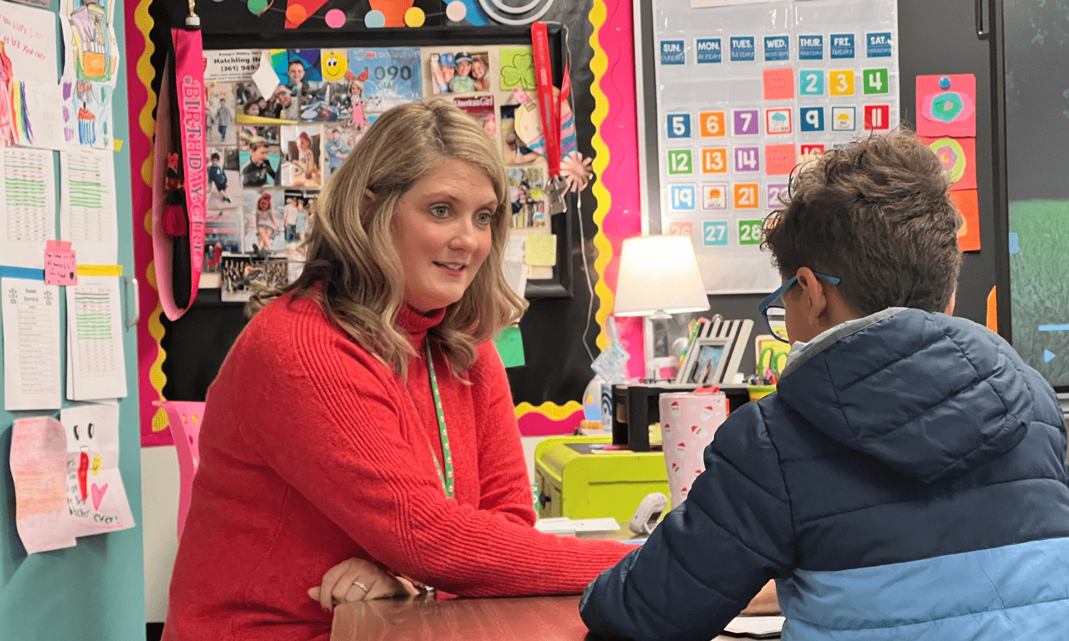 Teacher helping elementary student in the classroom